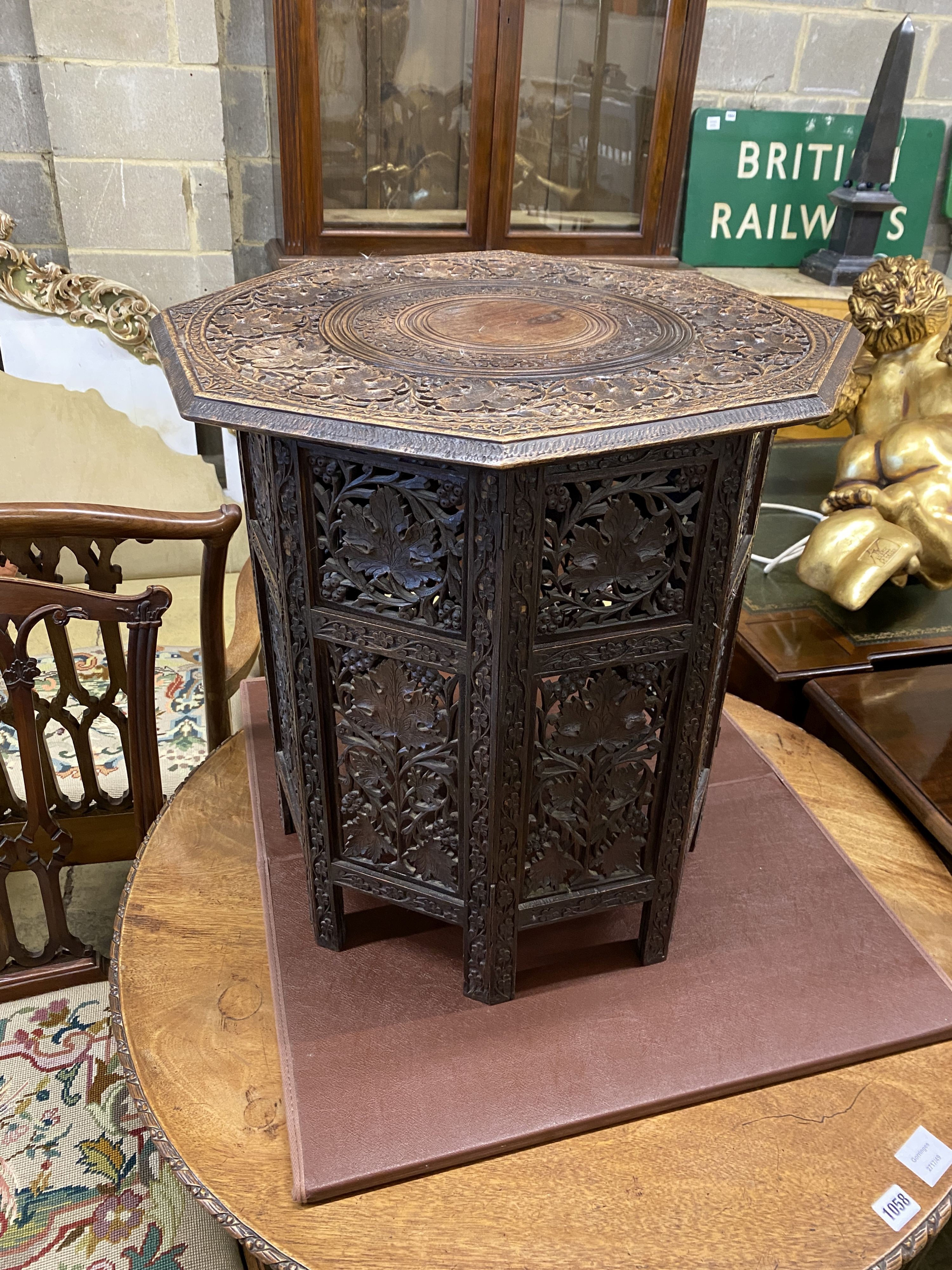 An Indian carved hardwood octagonal occasional table, width 53cm, height 55cm